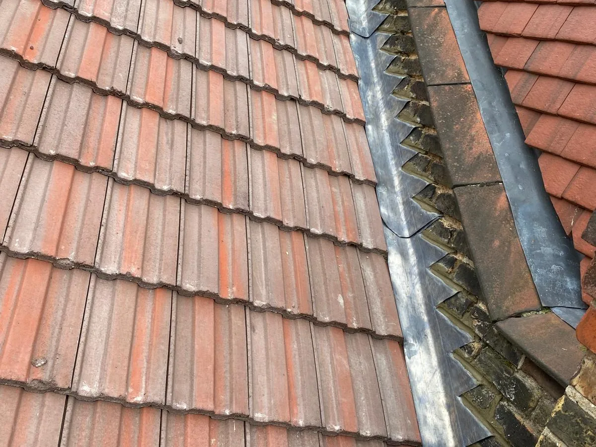 New ridge tiles on a red tiled roof