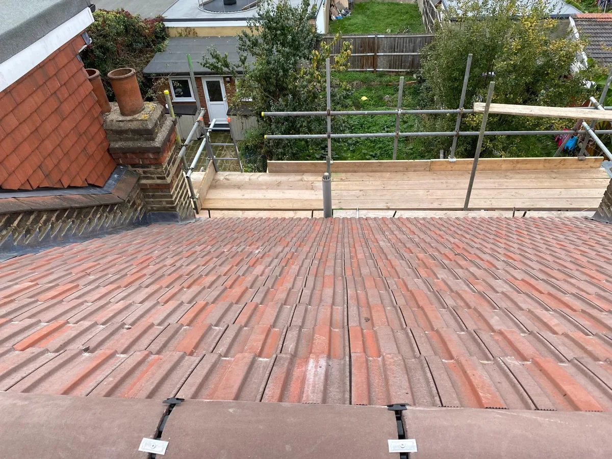 A red tiled roof with new ridge tiles