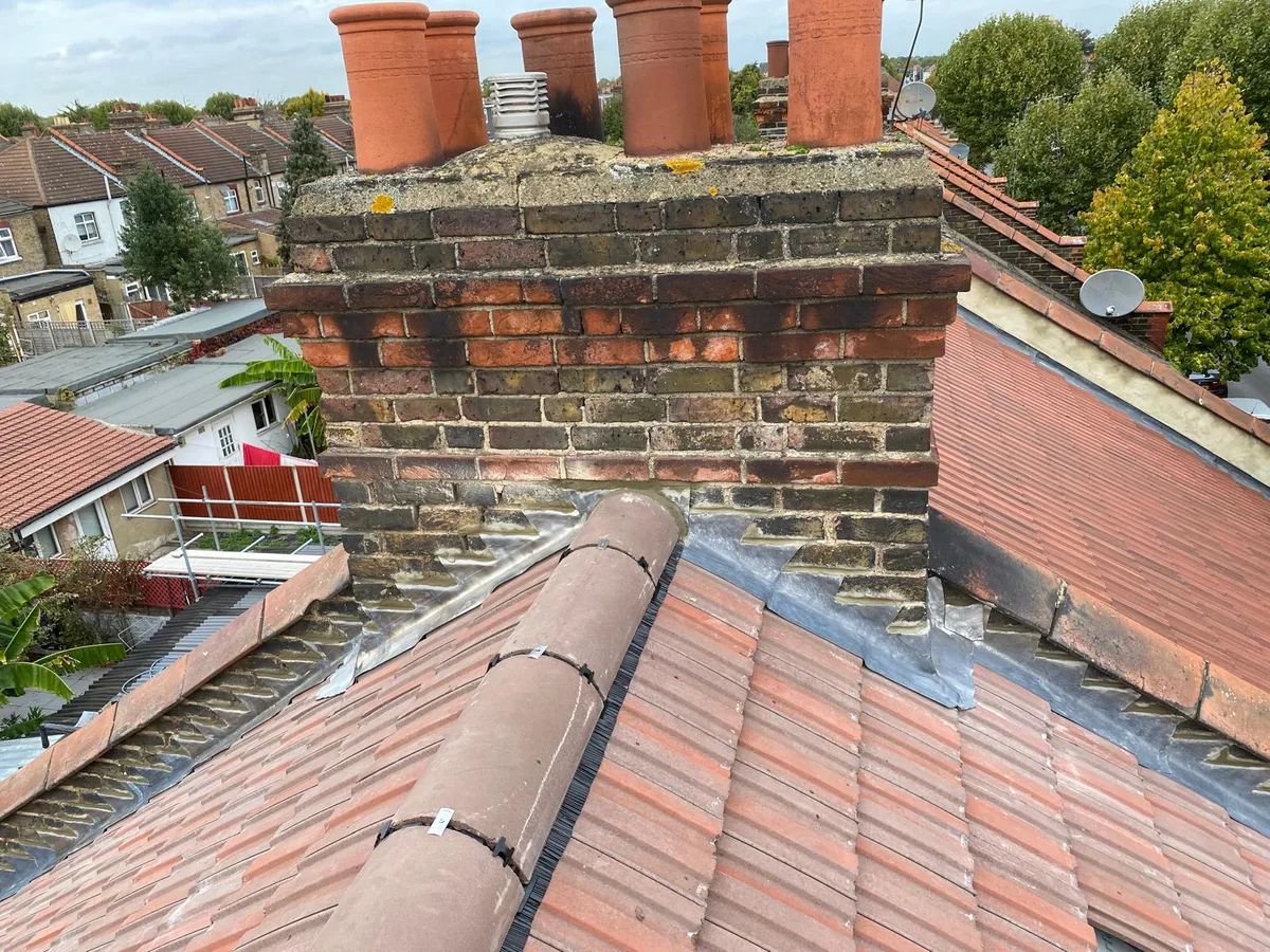 New ridge tiles beside a repaired chimney