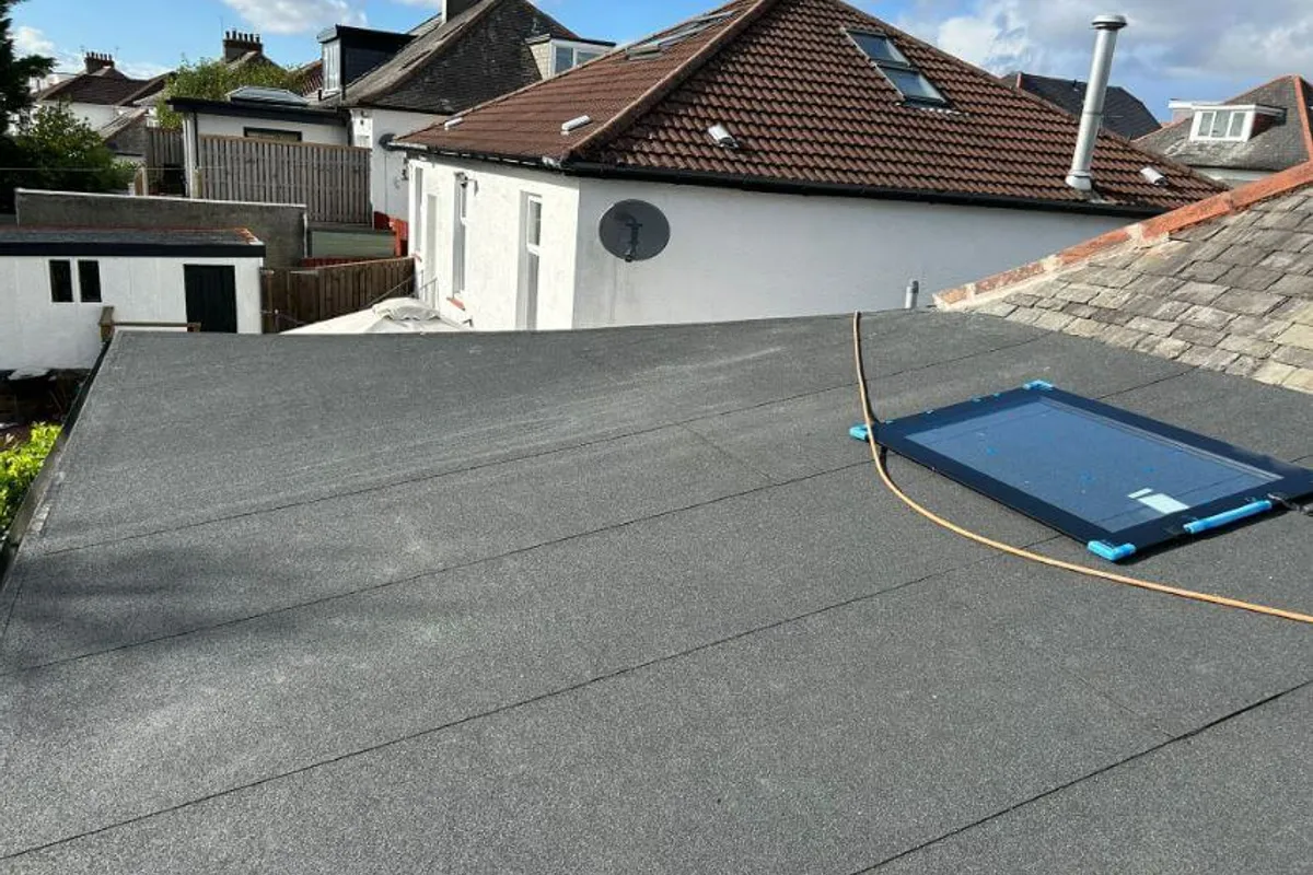 A torch-on felt flat roof finished with a mineral cap sheet