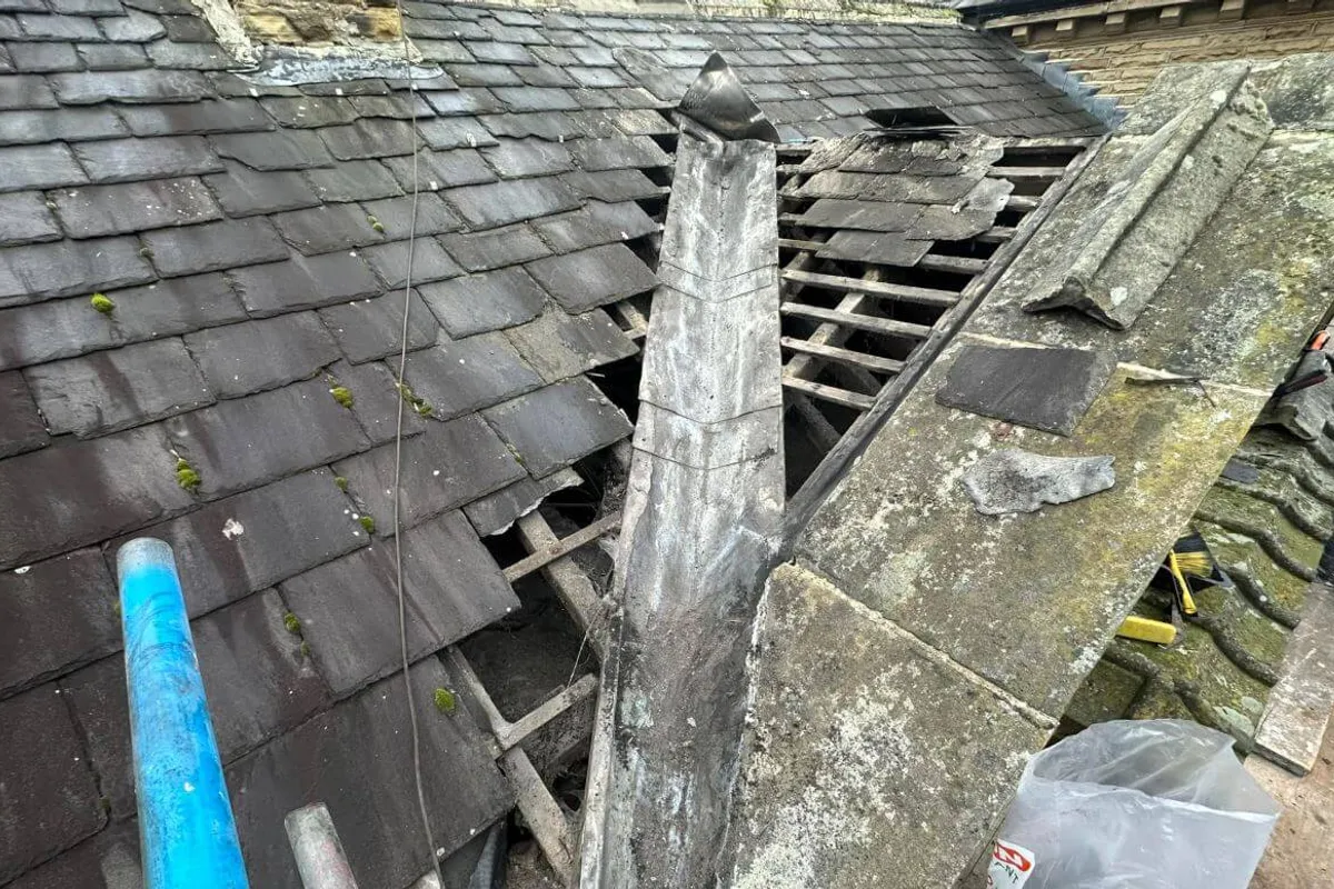 A roofer carrying out a repair on a pitched roof in Kent