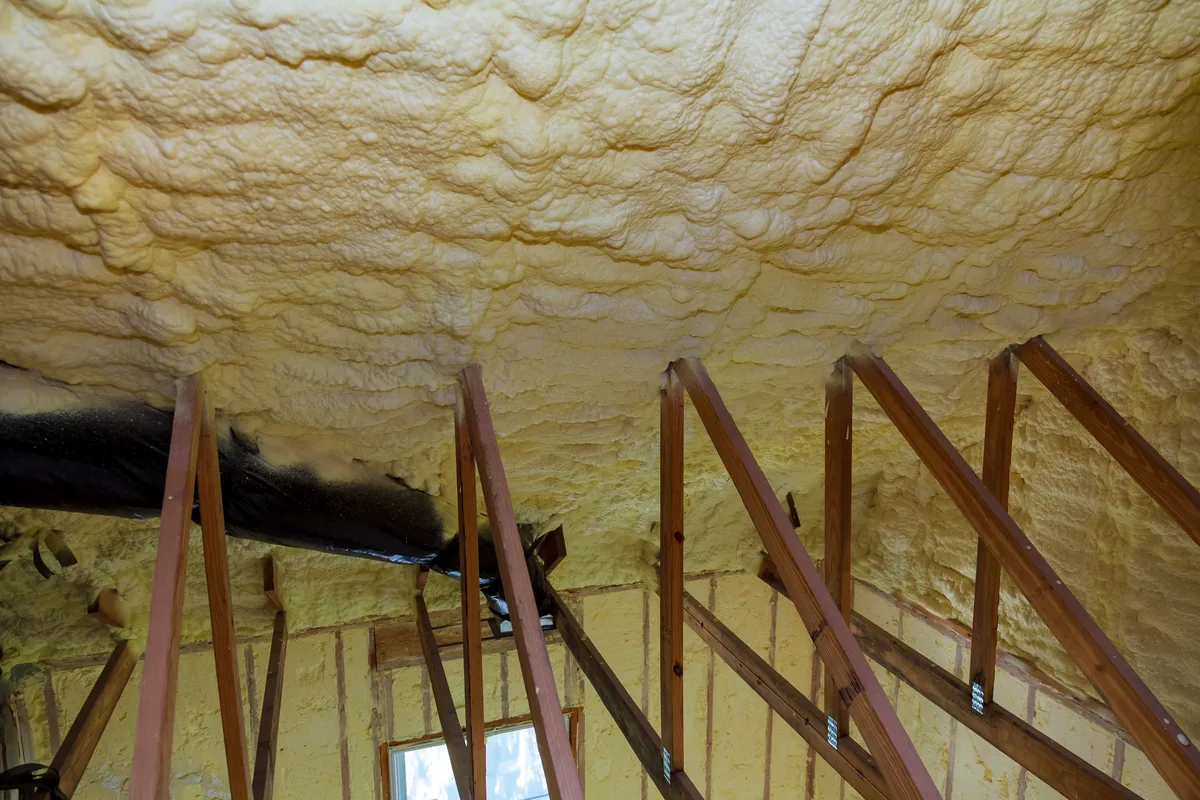 Insulation being removed from the underside of a roof